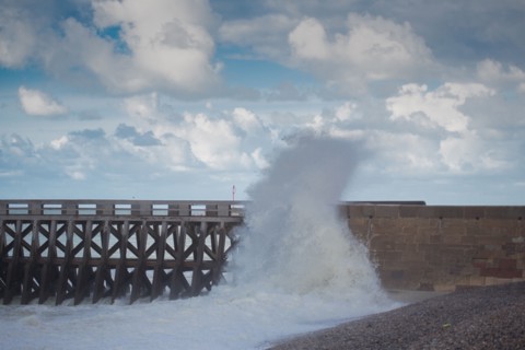 Wave flooding the dyke