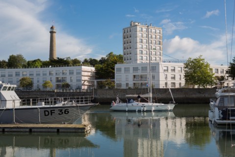 Lorient, port, grey customs boat and sailing boat leaving the port
