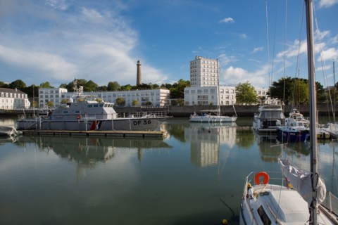 Lorient, port, grey customs boat and sailing boat leaving the port