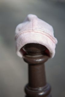 Paris, baby hat laid on a street post