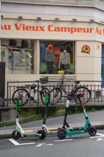Paris, bicycles and scooters in front of Le Vieux Campeur shop