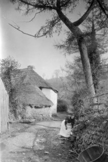 Woman fetching water, Bratton, Minehead, Somerset, c1900