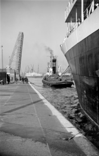 A ship being towed into the King George V Dock, Canning Town, London, c1945-c1965