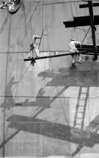Two men painting a ship in the Royal Albert Dock, Canning Town, London, c1945-c1965