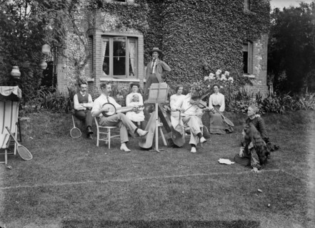 People playing music in a garden, c1896-c1920