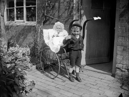 Child with a baby in a pram, Hellidon, Northamptonshire, 1900