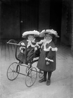 Two children and a pram, c1896-c1920
