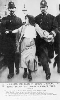 A 'Lancashire lassie' escorted through the palace yard, Westminster Palace, London, March 1907. Artist: Unknown