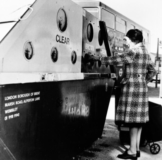 Woman using a bottle bank in Brent, London, c1950s. Artist: Henry Grant