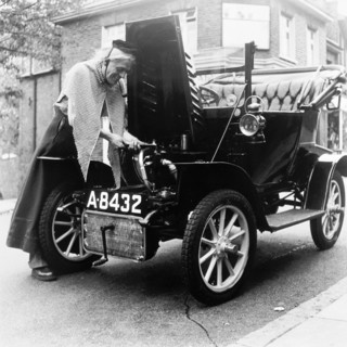 Man in fancy dress with a veteran car, London, (c1960-c1980?). Artist: Henry Grant