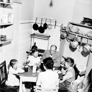 A family dining in their London home, c1950s. Artist: Henry Grant