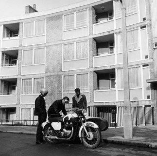 Men with a motorbike, Queen's Crescent, St Pancras, London, 1965.  Artist: Henry Grant
