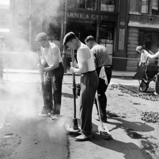 Workers repairing Queen Victoria Street, Westminster, London, 1955. Artist: Henry Grant