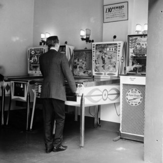 Man playing pinball in a London amusement arcade, c1966-67. Artist: Henry Grant