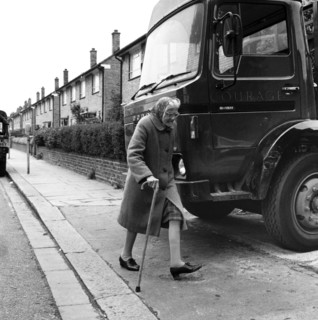 Old woman and truck on a London street, 1977. Artist: Henry Grant