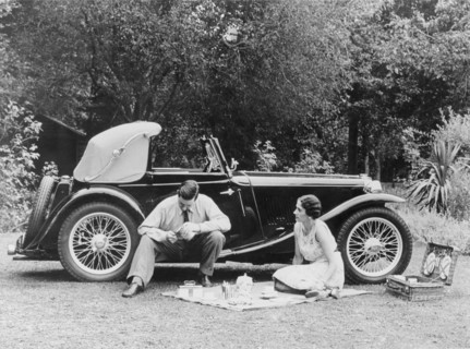 Couple having a picnic by an MG TA Midget, late 1930s. Artist: Unknown