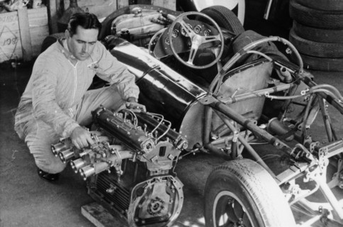 Jack Brabham inspecting the engine of a car. Artist: Unknown