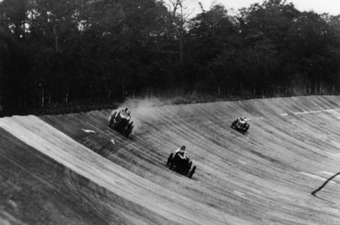Louis Zborowski passing Humphrey Cook's Ballot by skidding above him, Brooklands. Artist: Unknown