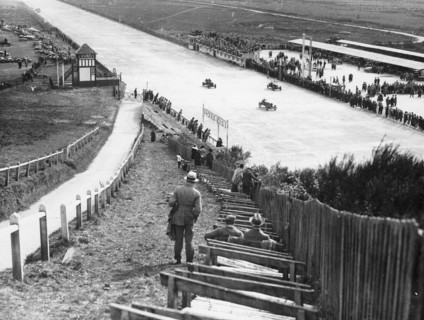 Spectators watching motor racing from the Test Hill, Brooklands, Surrey, (1920s?). Artist: Unknown