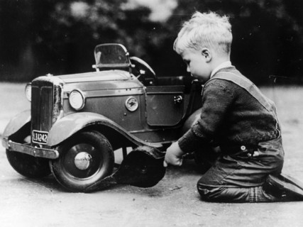Michael Ware repairing a pedal car. Artist: Unknown