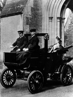 Two chauffeurs driving a convertible City and Suburban electric car. Artist: Unknown