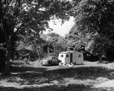 A family relaxing on holiday with their 1951 Vauxhall Wyvern and caravan, (1951?). Artist: Unknown