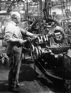 Man operating machinery in a car factory. Artist: Unknown