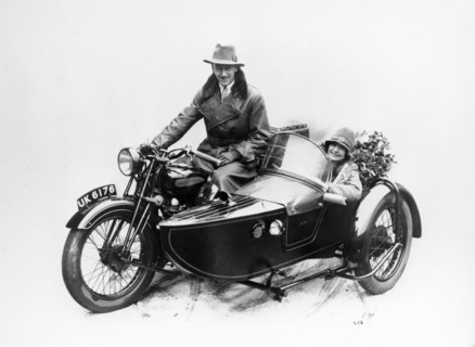 Man riding an AJS motorbike with a woman in the sidecar, 1939. Artist: Unknown