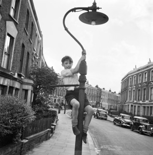 Boy climbing a lamppost, Kentish Town, London, 1960-1965