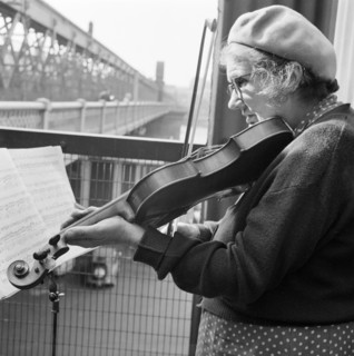 Woman busker playing the violin, Hungerford Bridge, London, 1946-1959