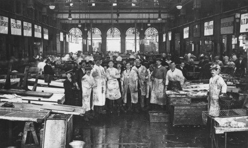 The interior of Billingsgate Market showing fishmongers and their stalls, London, c1918. Artist: Unknown