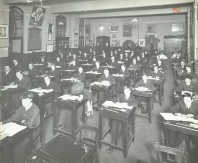 Examination class for male and female students, Queen's Road Evening Institute, London, 1908. Artist: Unknown.