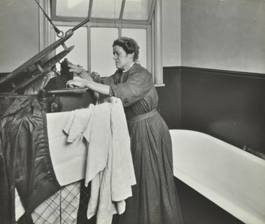 Nurse using a steriliser in the bathroom at Chaucer Cleansing Station, London, 1911. Artist: Unknown.