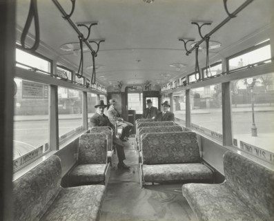 Men in hats and coats in the interior of an electric tram, London, 1933. Artist: Unknown.