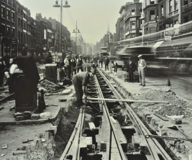 Men laying tramlines in the middle of the road, Whitechapel High Street, London, 1929. Artist: Unknown.
