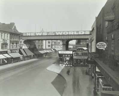 Railway bridge and advertising over the Brixton Road, Lambeth, London, 1938. Artist: Unknown.