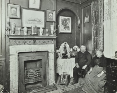 Elderly couple in Victorian interior, Albury Street, Deptford, London, 1911. Artist: Unknown.