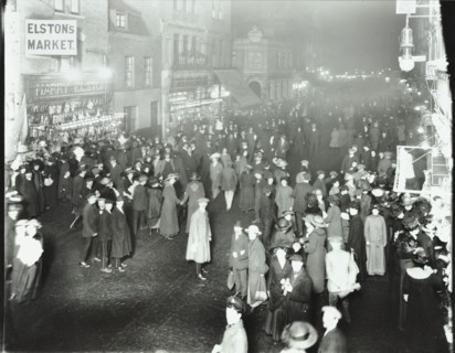 Crowds in Deptford High Street shopping after dark, London, 1913. Artist: Unknown.
