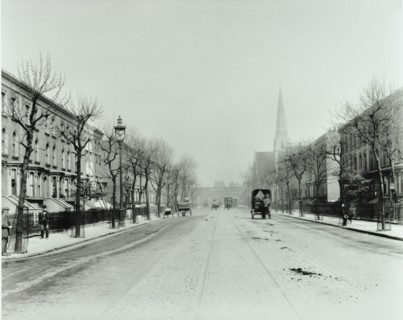 Broad tree-lined street with tramlines, Burdett Road, Stepney, London, 1912. Artist: Unknown.