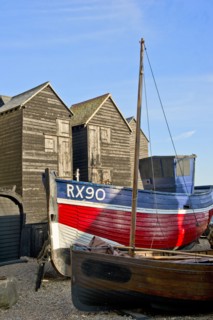 Fishing boat on the beach in front of the 'net shops', Hastings, East Sussex, c1980-c2017