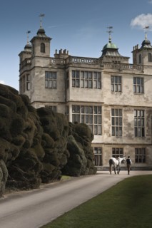 Re-enactor leading a horse towards Audley End House, Saffron Walden, Essex, 2010