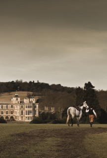 Re-enactor leading a horse towards Audley End House, Saffron Walden, Essex, 2010