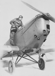 Aerial photographer getting into an aeroplane, c1930s