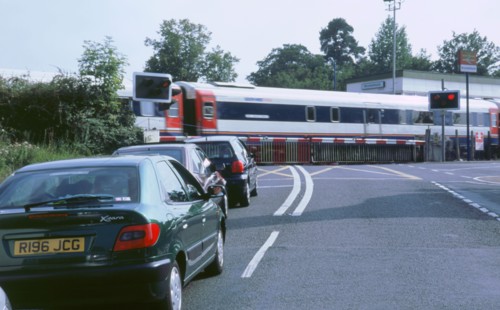 Traffic queue at level crossing in Brockenhurst, Hampshire. Artist: Unknown.