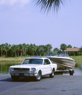 1967 Ford Mustang towing a boat. Artist: Unknown.
