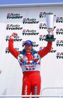 Matt Neal, Nissan driver, celebrates victory, 1999 British touring cars. Artist: Unknown.