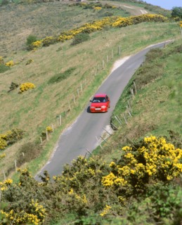1996 Suzuki Baleno GS Sport on winding country lane,Dorset. Artist: Unknown.