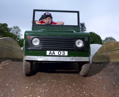 Children driving a toy Land Rover. Artist: Unknown.