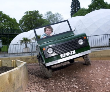 Child driving a toy Land Rover. Artist: Unknown.