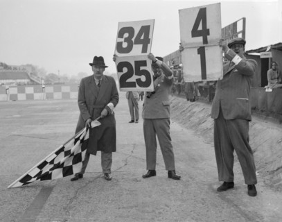 Ready to wave the chequerd flag, Brooklands. Artist: Bill Brunell.